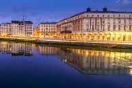 City of Bayonne in France at night with houses of typical architecture and reflections on the Adur River. Europe.